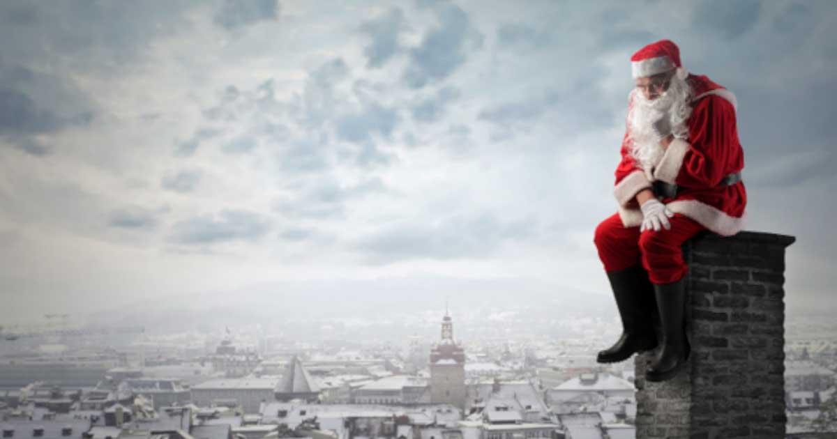 A sad Santa sat on a chimney, lamenting the banning of Christmas. Source: Olly / Adobe Stock