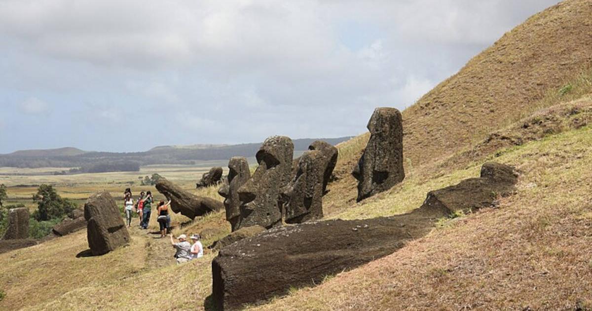 Statue heads on Easter Island in various stages of completion before they were abandoned in a crater.   