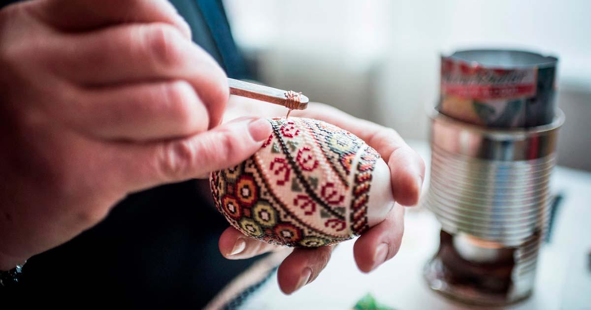 Lady making traditional decorated eggs in the Bukovina Region of Romania. Source: Matthew / Adobe Stock. 
