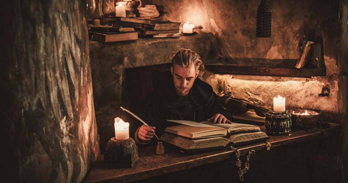Monk chronicler writes an ancient manuscript. Source: Nejron Photo / Adobe Stock