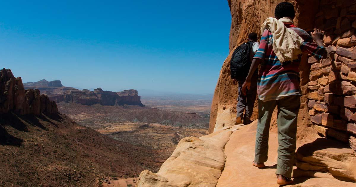Towards the rock-hewn church of Abuna Yemata Guh in Tigray Ethiopia. Source: Reto Ammann / Adobe Stock.