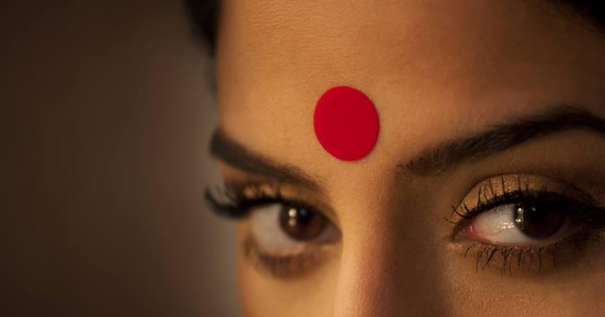 Close-up of a woman's eyes and red bindi.