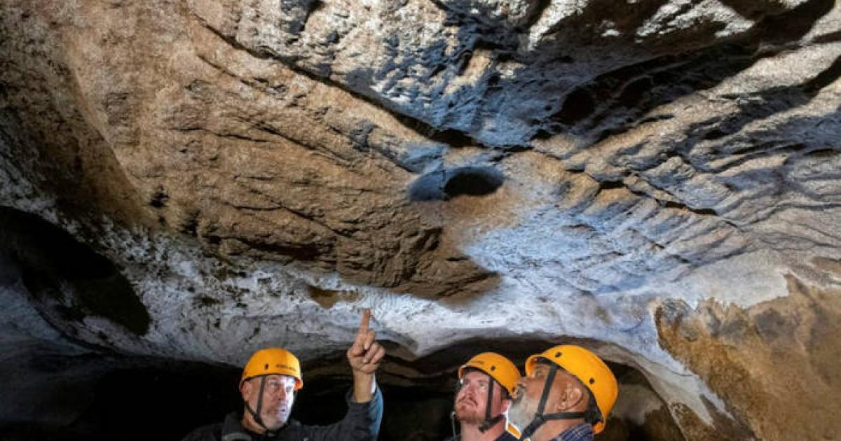 Mal and Dylan Siely examine finger grooves at Waribruk with GunaiKurnai Elder Uncle Russell Mullett