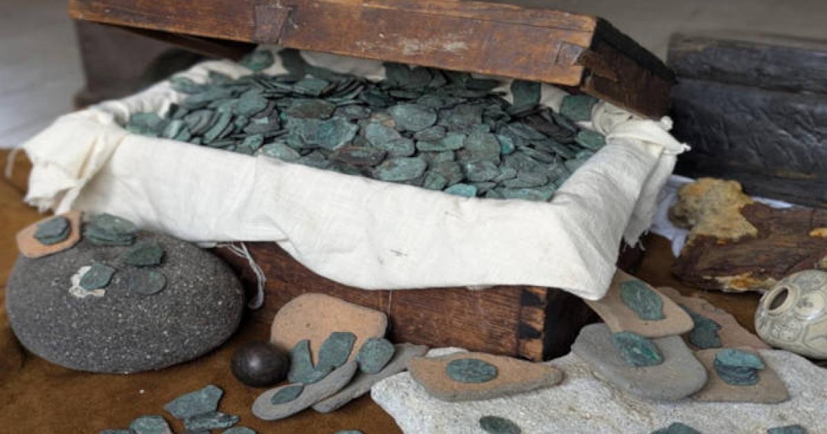 Some of the coins and treasure from the wrecksite, in a modern treasure chest.