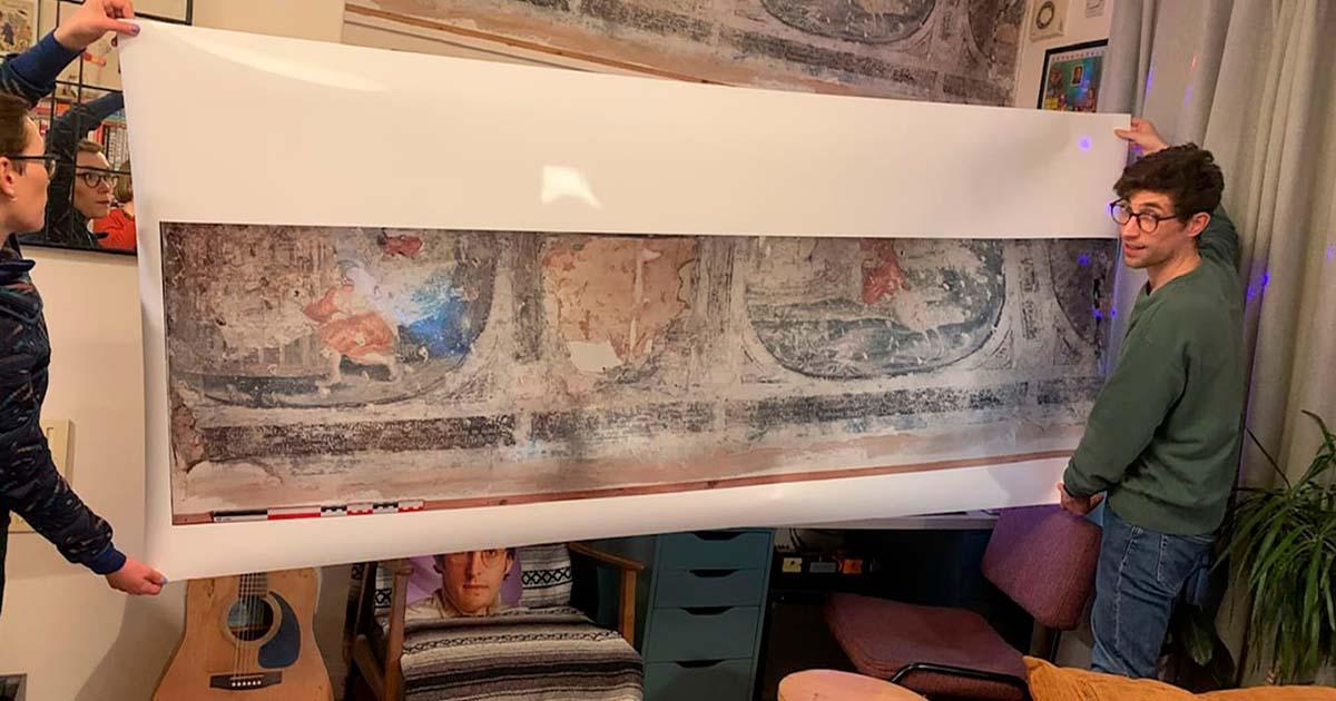 Home owner Luke Budworth posing with the frescoes in York and the life-size reproduction produced by Historic England. Source: Luke Budworth