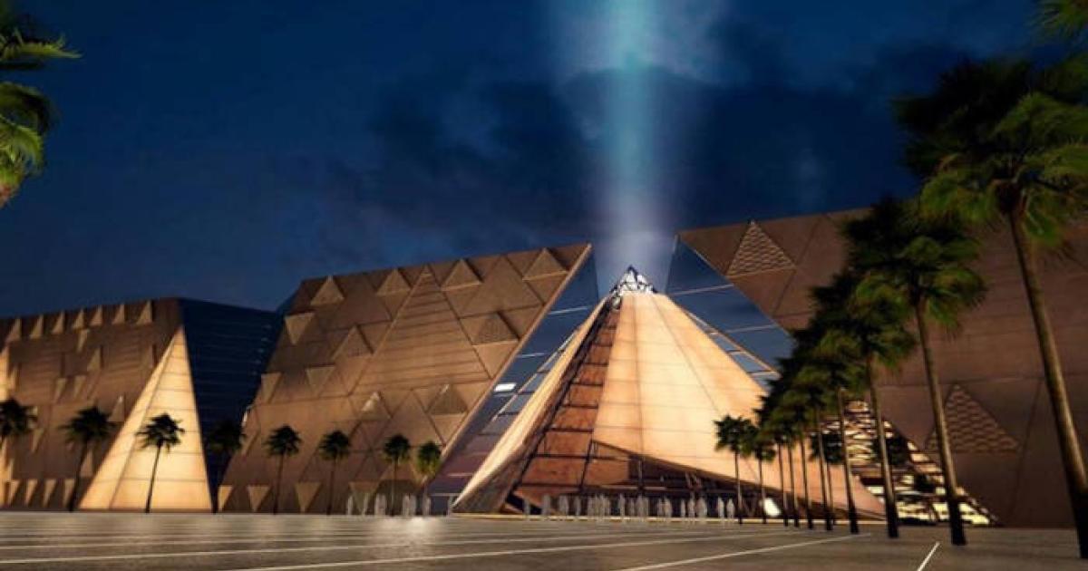 Exterior view of the Grand Egyptian Museum at night.
