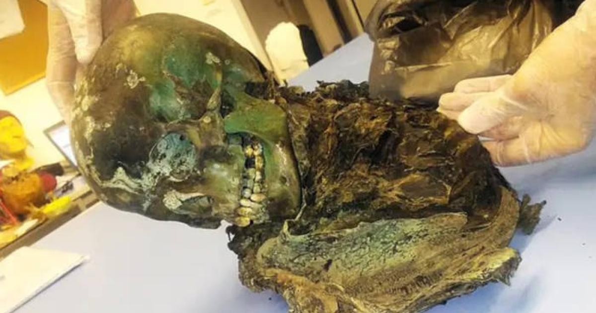 The mummified remains of the teenager, colored green.