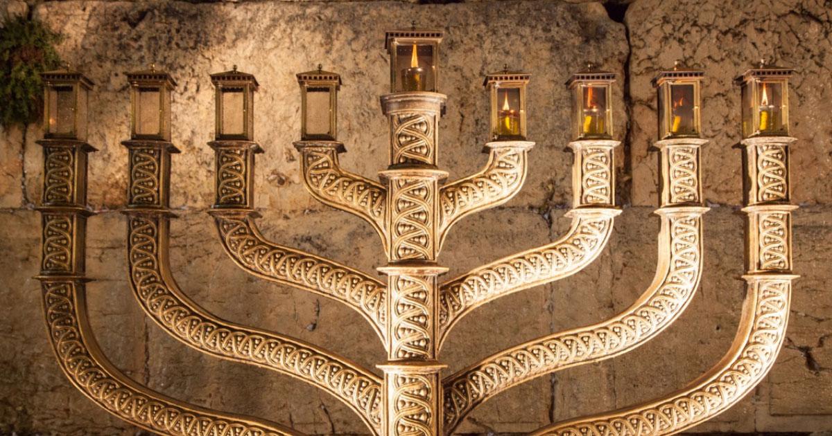 Hanukkah menorah with wailing wall in the background