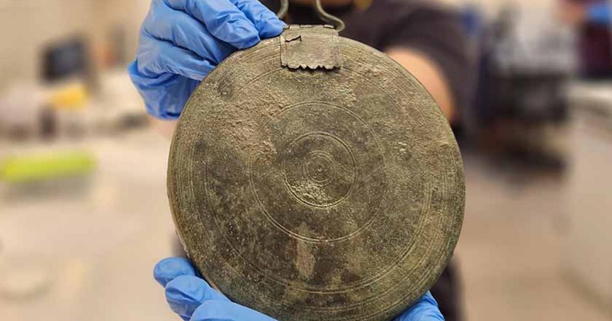 The perfectly preserved bronze mirror found in a shallow grave alongside the Hellenistic escort. Source: Yoli Schwartz / Israel Antiquities Authority