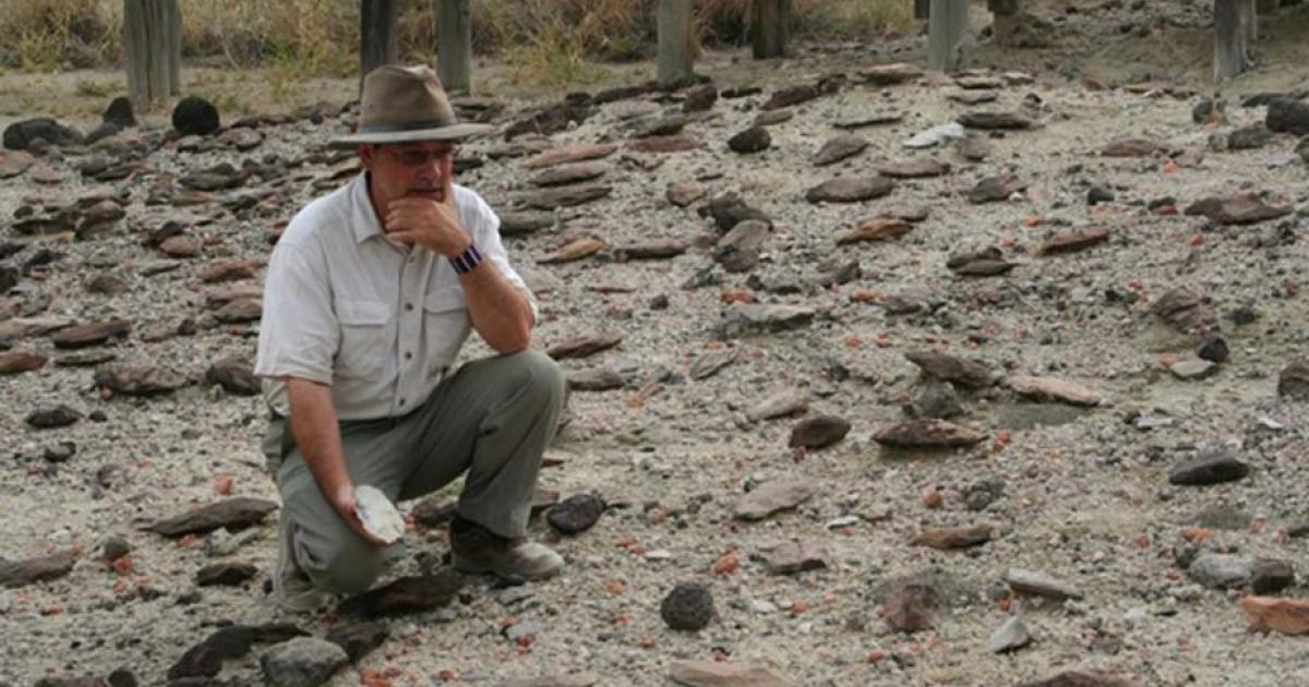 Rick Potts, director of the National Museum of Natural History’s Human Origins Program at the Smithsonian, surveys an assortment of Early Stone Age hand-axes discovered in the Olorgesailie Basin, Kenya.