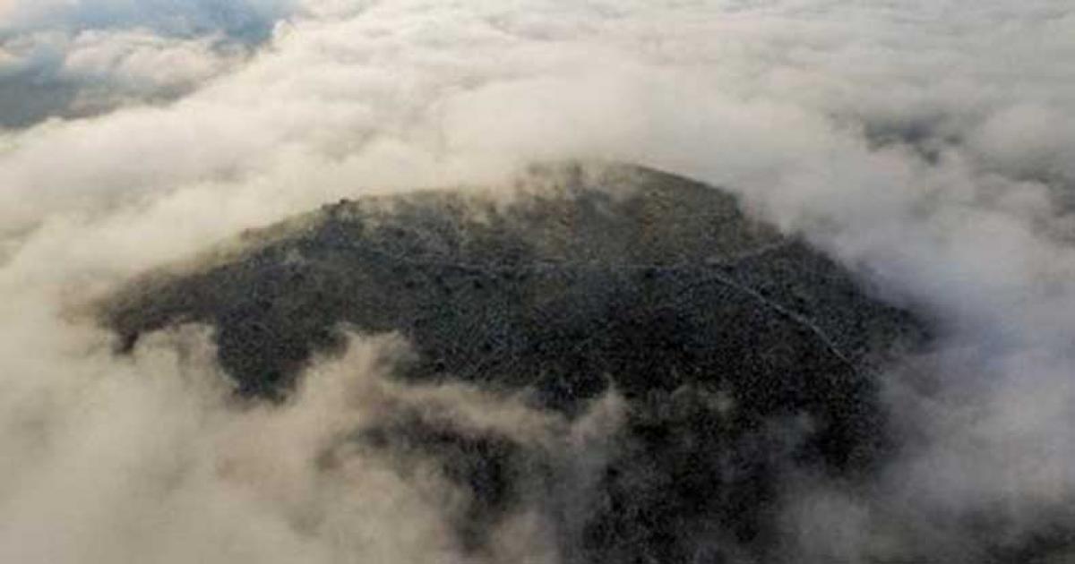 The city’s acropolis is barely visible on the hill on a cloudy day. 