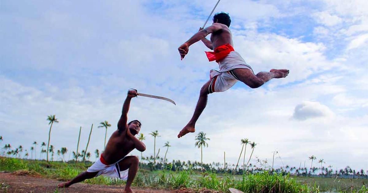 Two Kalaripayattu swordsmen in mock sword against sword combat in Kerala. This Indian martial art is still very much alive today!