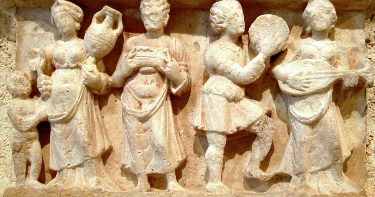 Hellenistic culture in the Indian subcontinent: Greek clothes, amphoras, win,e and music. Detail from Chakhil-i-Ghoundi Stupa, Hadda, Gandhara, 1st century AD. 