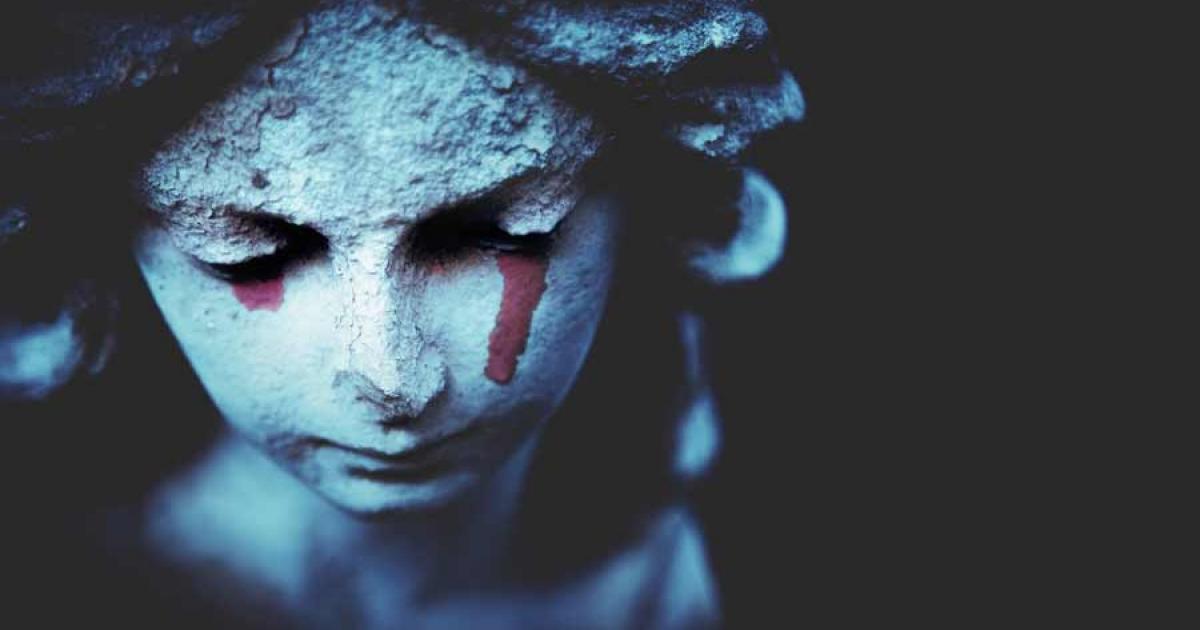 Close up of an ancient crying angel statue with tears as a symbol of the end of human life. According to the latest research burial customs in Iron Age Britain frequently involved the keeping and burial of everyday objects associated with the deceased. Source: zwiebackesser / Adobe Stock
