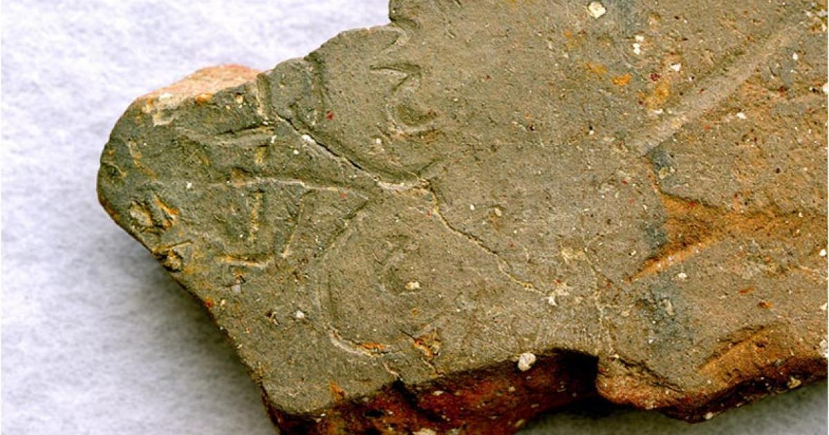 A tile inscribed with the character for “flight” goes on display in a Japanese museum. The tile is from the site of Japan's first Buddhist temple (Yoshinori Toyomane)