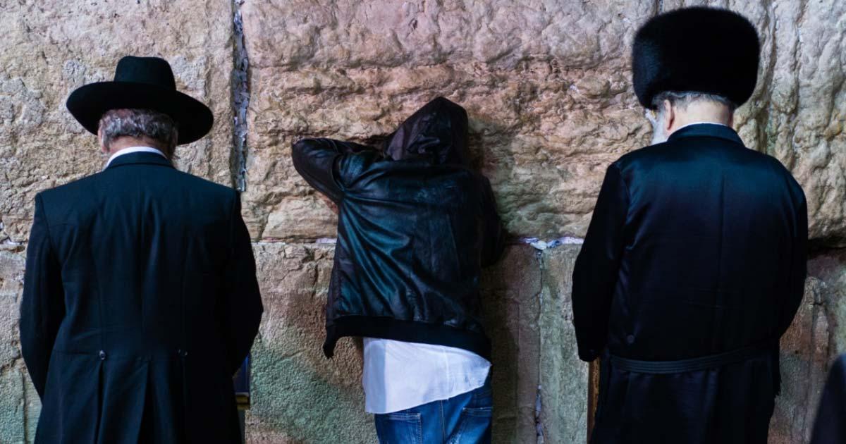 Three different Jewish people giving Selichot prayers at the Wailing Wall, Jerusalem 