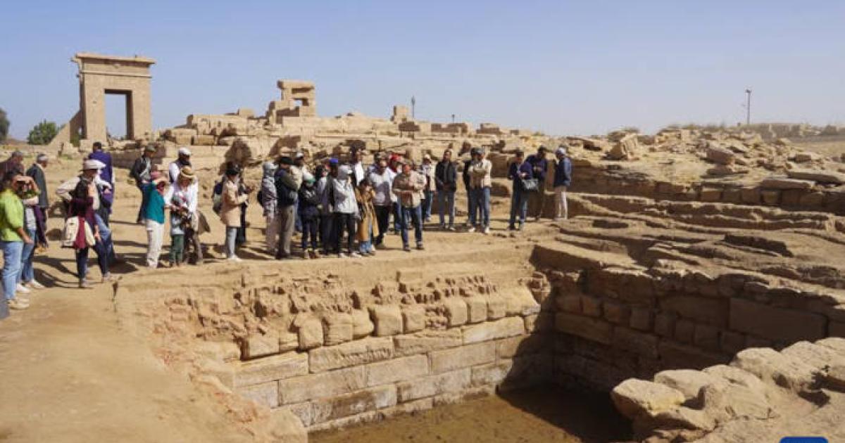 : Guests visit the ruins of the “sacred lake” at the Montu Temple precinct, Karnak, Luxor.