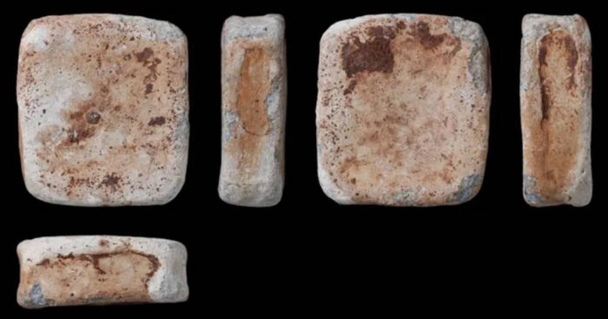 One of three lead ingots discovered with seven bronze items by a metal detectorist near Dereham, Norfolk