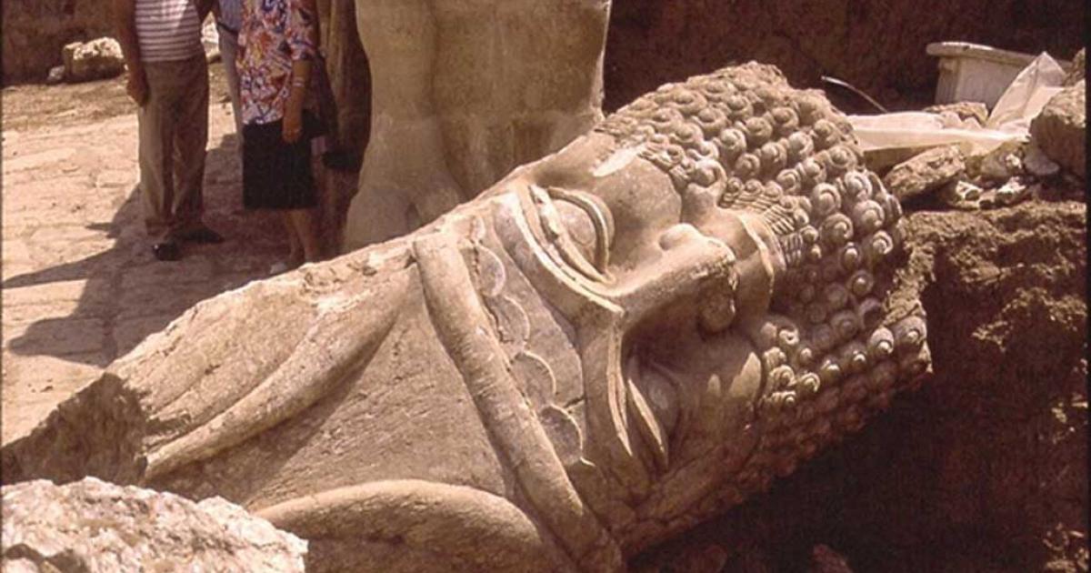 The now destroyed Nebi Yunus in Nineveh. Iraqi archaeologists excavate the monumental entrance to a late Assyrian building. The large head of a bull-man sculpture lies in a passageway.