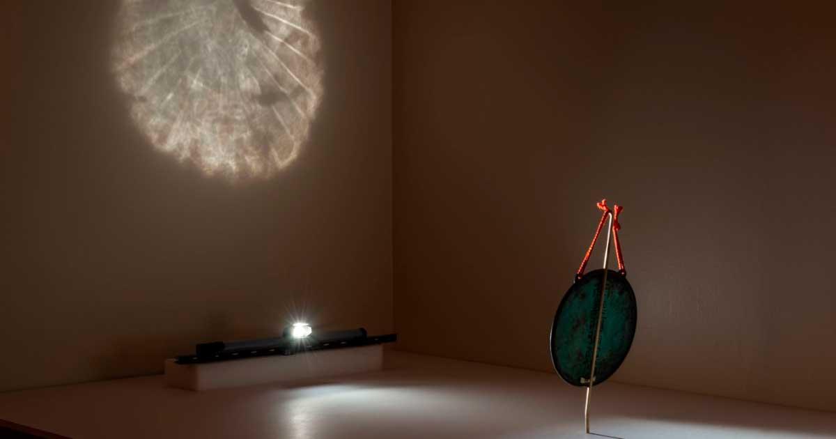 Demonstration of Buddhist Bronze Mirror reflecting its image at the Cincinnati Art Museum. Source: Rob Deslongchamps/Cincinnati Art Museum