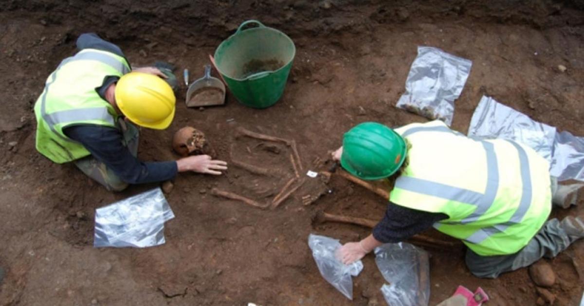 Archaeologists exhume a body from the quadrangle of Robert Gordon College in Aberdeen, Scotland. 