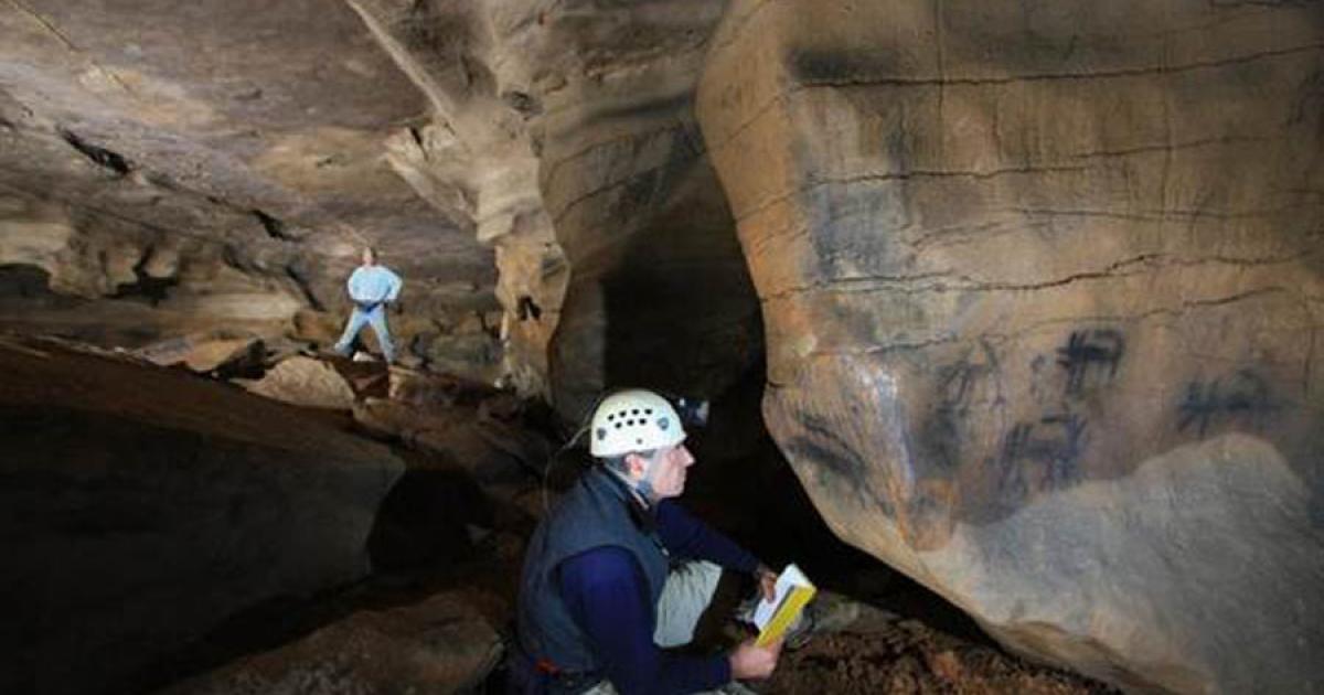 Jan Simek, professor of anthropology, next to Mississippian Period cave drawings.		Source: University of Tennessee Knoxville