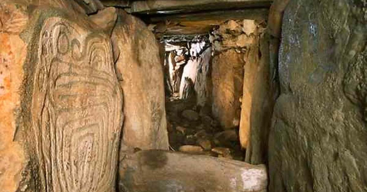 Western passage at the megalithic site of Knowth with decorated orthostat on left. Co. Meath, Ireland.