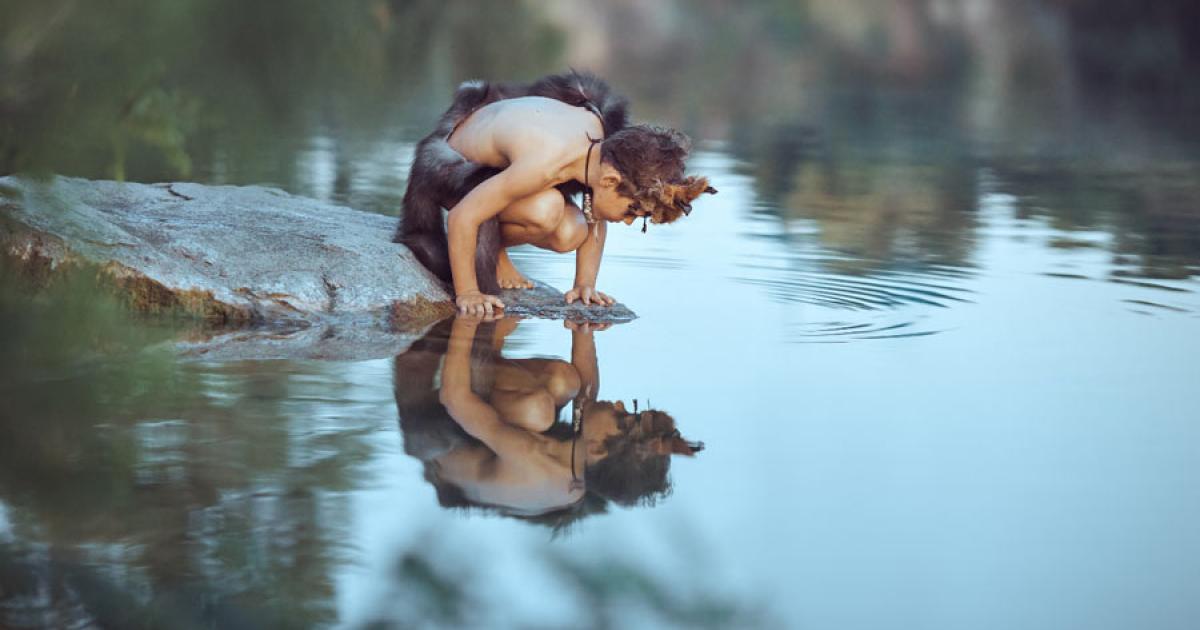 A Neanderthal boy looking at his reflection not knowing that Neanderthal development was faster than that of modern humans. Some kids have it easier!		Source: EmotionPhoto / Adobe Stock