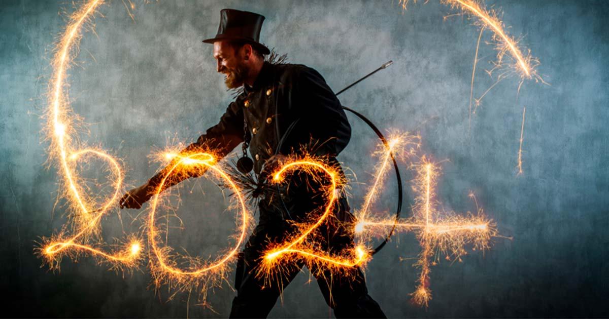 Chimney sweep in work clothes writes the year 2024 with sparklers. Source: Werner/Adobe Stock