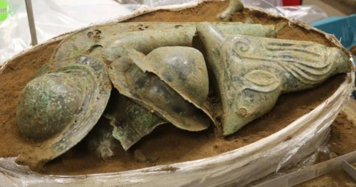 The Iron Age hoard from Norfolk, showing shield bosses in the center with the boar's head visible on the right, and the carnyx at the back