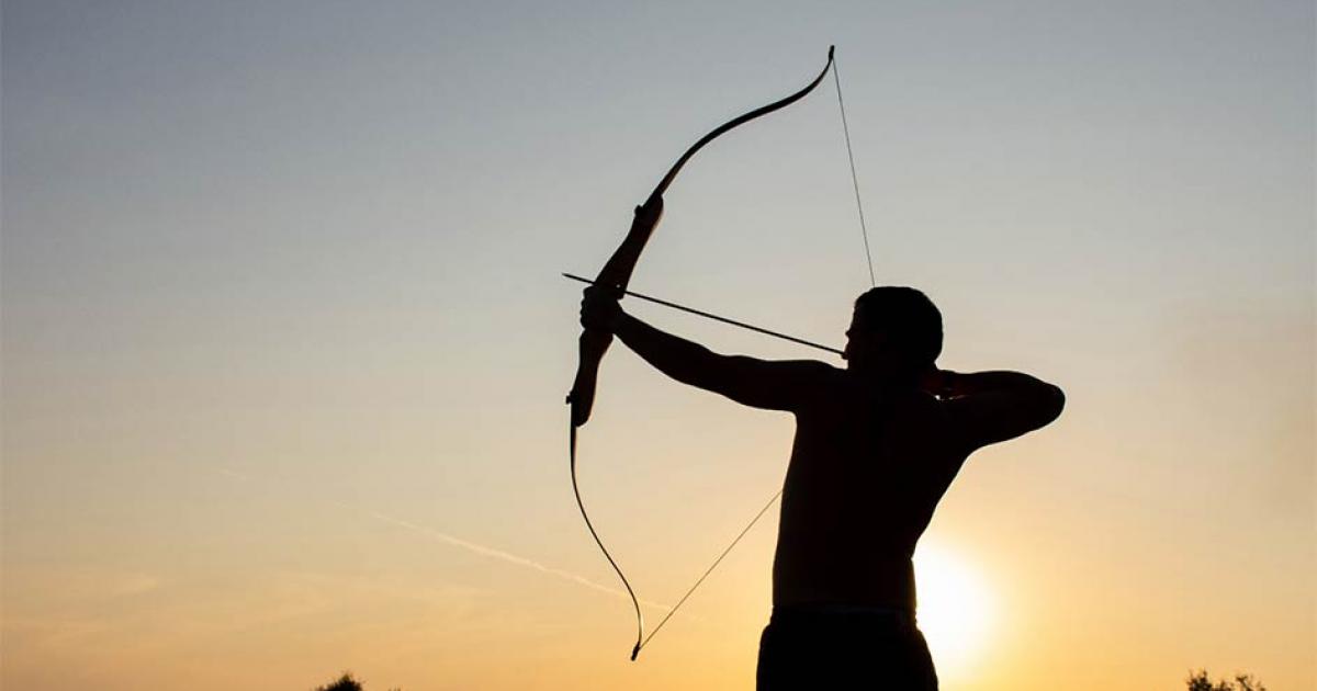 Man using bow and arrow. Credit: Oksana Volina / Adobe Stock