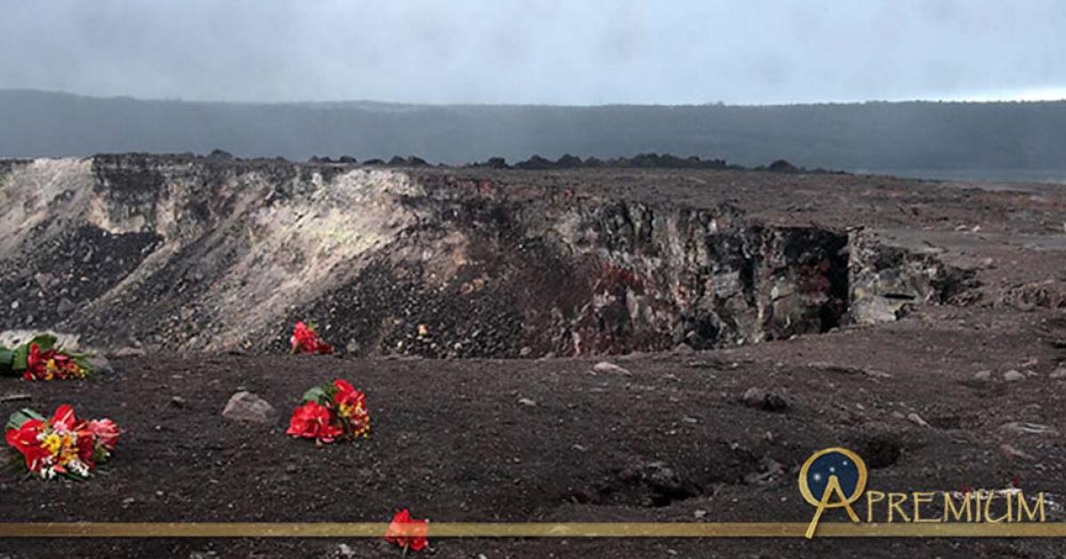 Red flowers apparently left as an offering for the volcano goddess Pele at the edge of the Halema'uma'u Crater in the Kilauea caldera at Volcanoes National Park on the Island of Hawaii