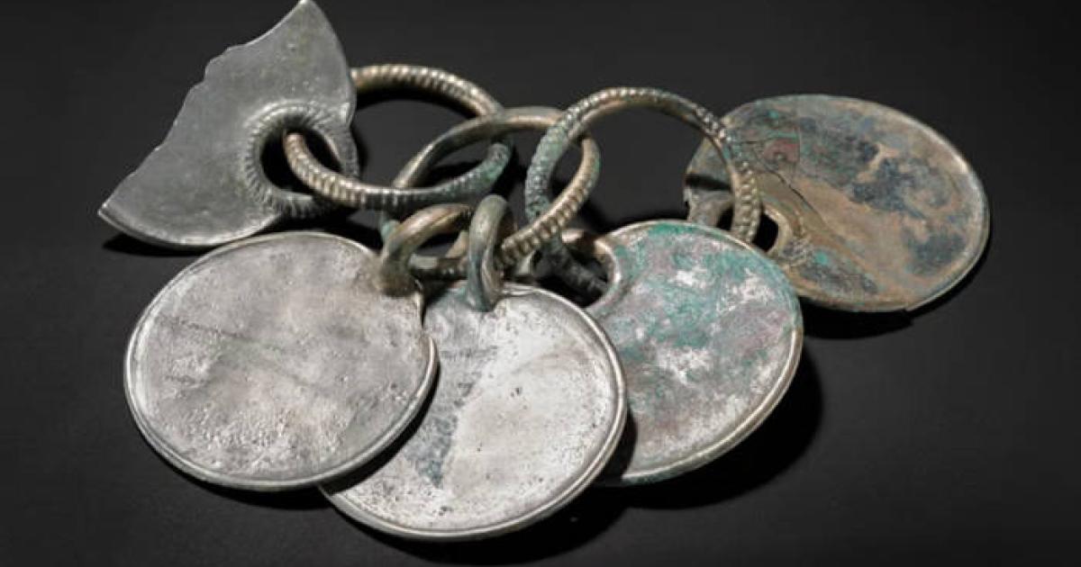 Item described as a Bronze rattle pendant from the Peebles hoard.