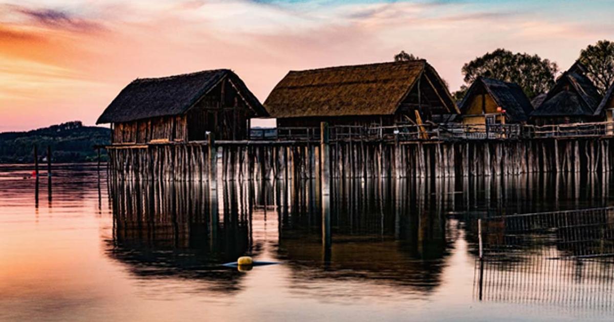 Colorful sunset at Lake Dwellings of the Stone and Bronze Age at Pfahlbaumuseum in Unteruhldingen on Lake Constance, Baden-Wurttemberg.