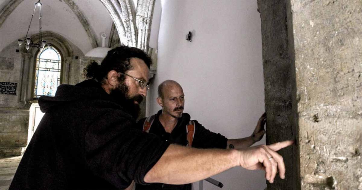 Researchers at the Tomb of David building, examining what they hope is the mark of Adrian von Bubenberg.	Source: IAA