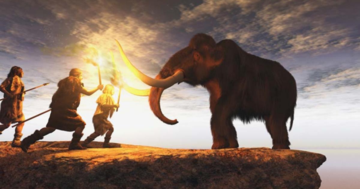 Prehistoric men hunting a young mammoth