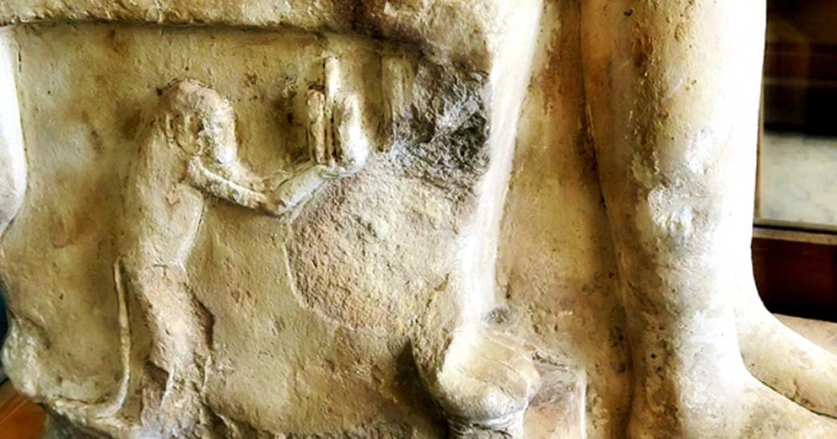 Detail from the side of a seat of a group sculpture shows a baboon holding a cosmetic pot or kohl eyeliner; design by Anand Balaji 