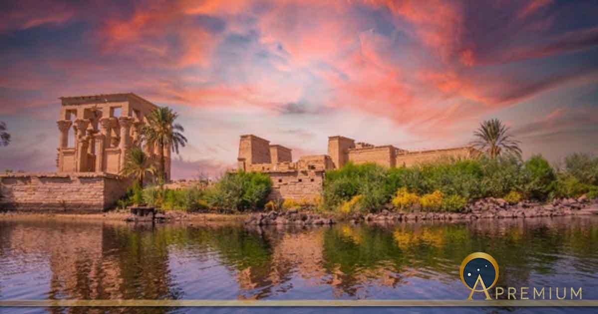 Incredible orange sunrise at the temple of Philae, a Graeco-Roman construction seen from the Nile river, a temple dedicated to Isis, goddess of love. (unai/Adobe Stock)
