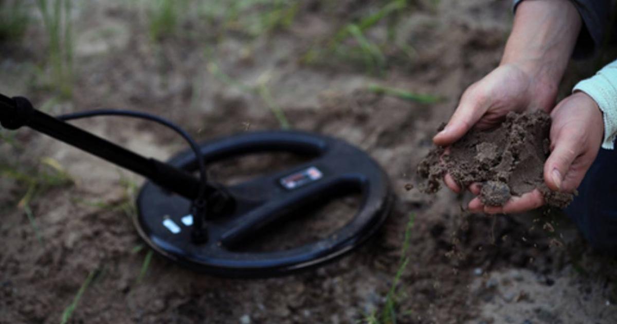 The treasure-hunters. Working with a metal detector. 