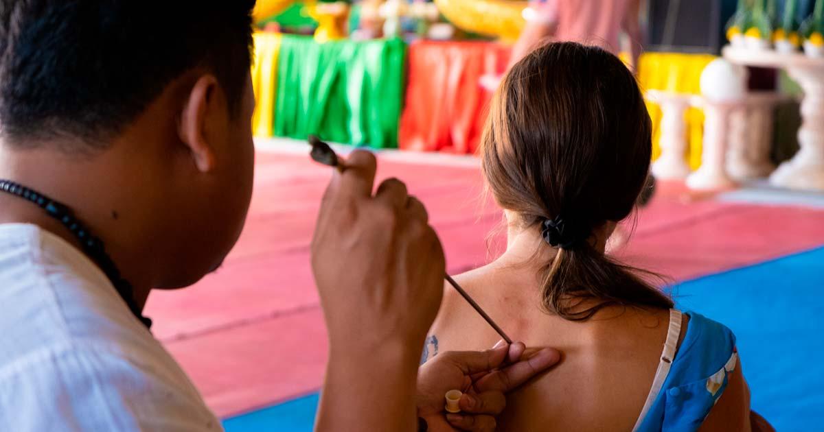 Thai Tattoo Master makes Sak Yant tattoo. Source: Denis / Adobe Stock.