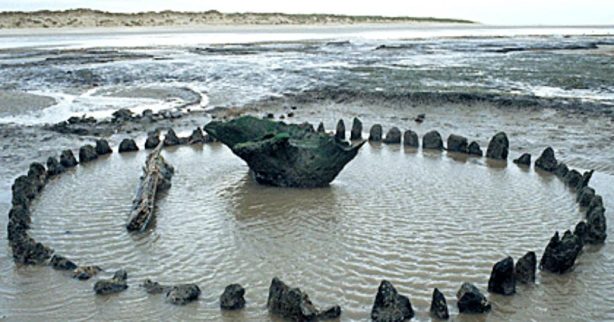 Seahenge – how it was found at low tide off the coast of Norfolk, England.     Source: Norfolk Archaeology Unit