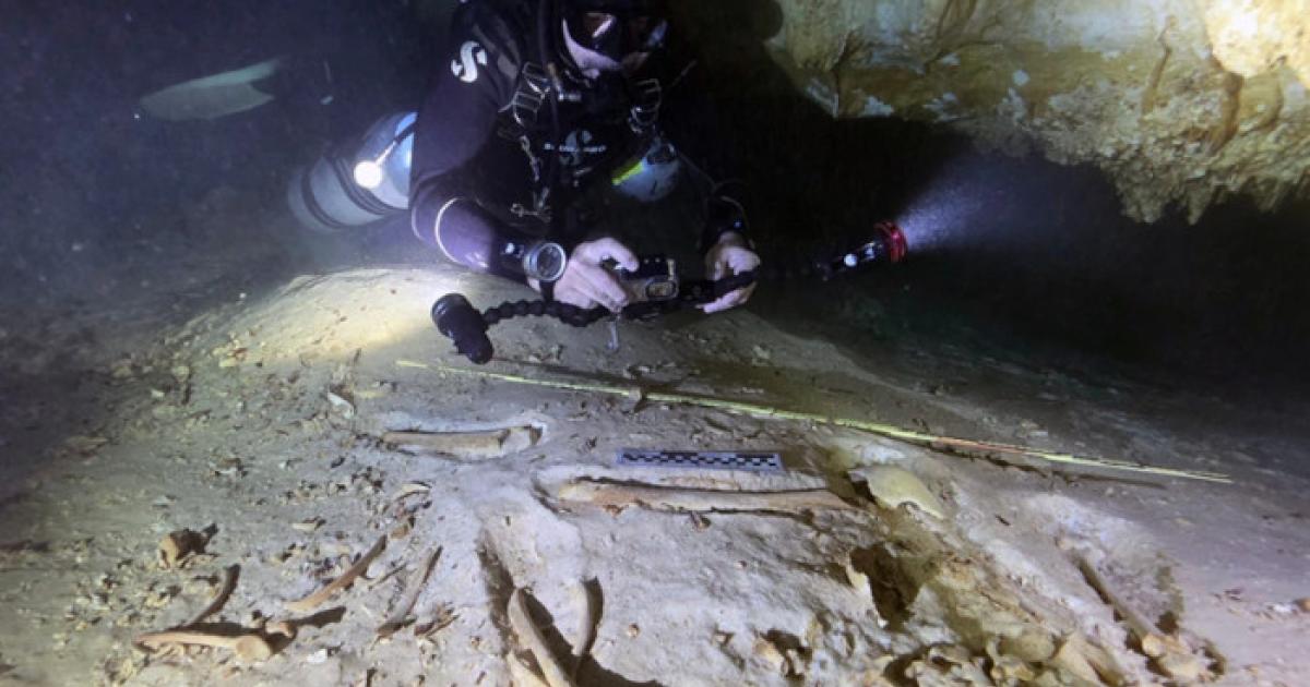 Underwater archaeologist Octavio del Río photographs the prehistoric skeleton discovered inside the flooded cave system in Actun, near Tulum, Mexico