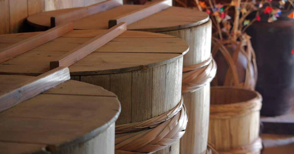 Wooden barrels used in Japanese soy sauce production. Source:  TeTsumi / Adobe Stock.