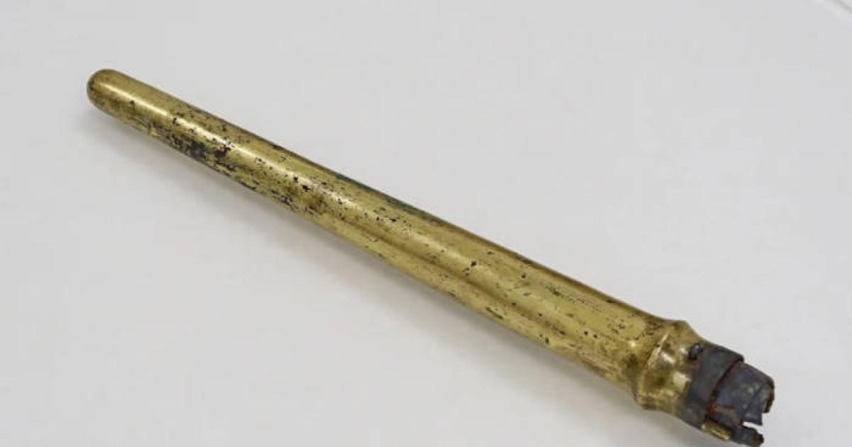Gilt bronze spear sheath containing iron spear.