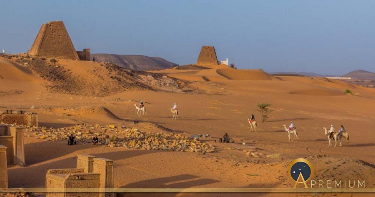 Locals on camels near Meroe pyramids, Sudan (Matyas Rehak/ Adobe Stock)