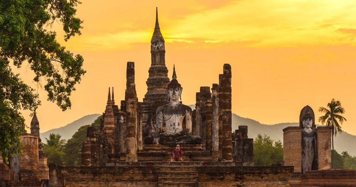 Ancient pagoda and big buddha at Sukhothai Historical Park, the birthplace of the Sukhothai Kingdom. Source: somrakjendee / Adobe Stock.