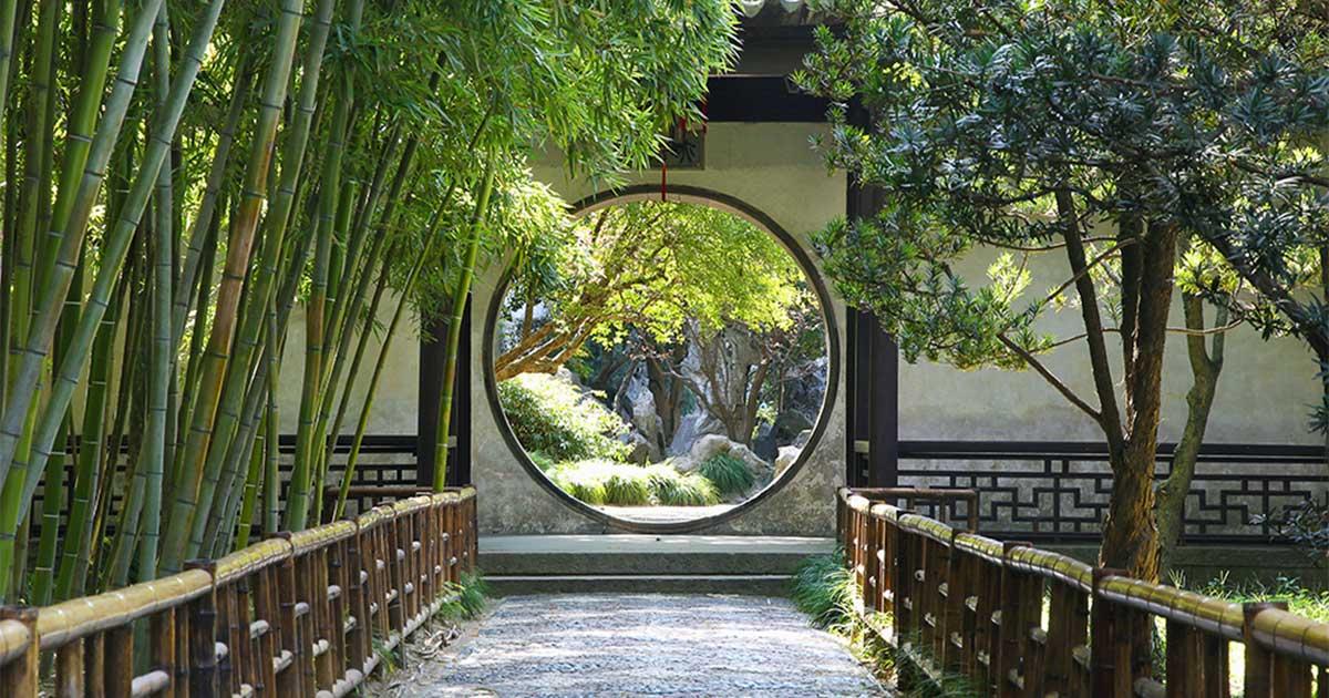 Circular gate in the Suzhou gardens. Source: rudiuk / Adobe Stock 