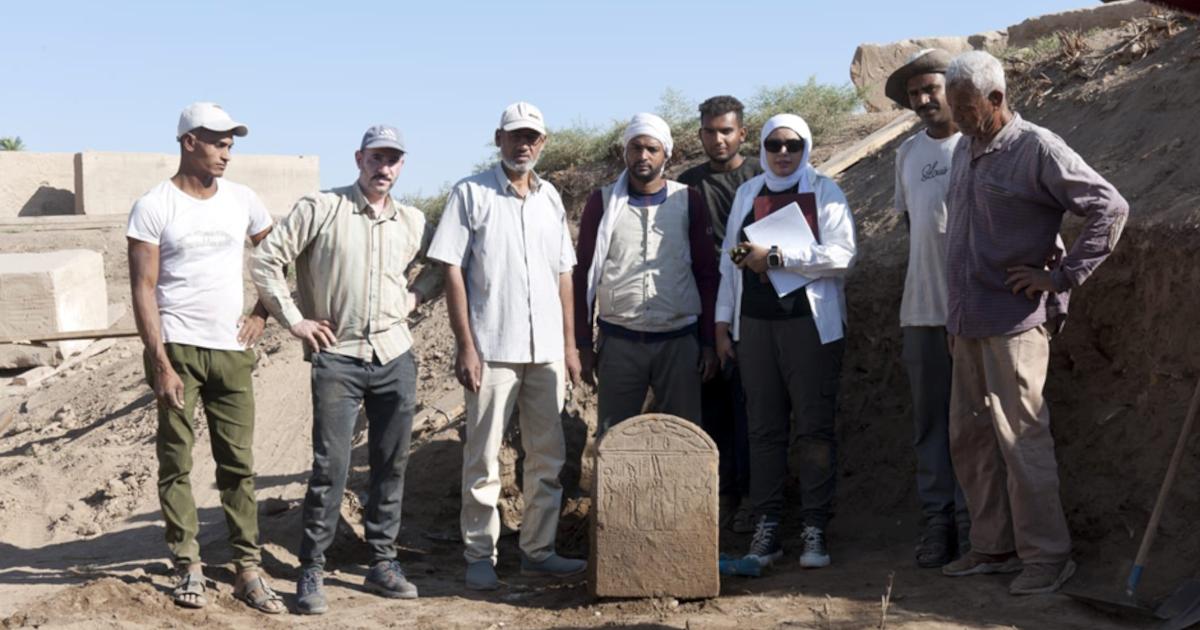 The Tiberius stele found at Karnak with some of the researchers on the project.