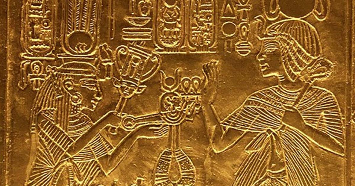 Scene from gilded shrine of Tutankhamen showing him and his wife Queen Ankhesenamun. Queen hols a sistrum and menat. 