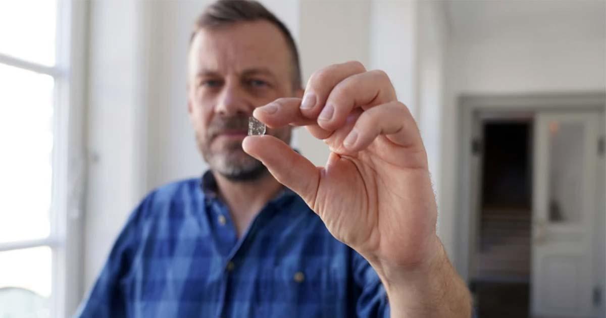 Senior Researcher at the National Museum of Denmark Mads Dengso Jessen holds a Viking Age window glass fragment. Source: John Fhær Engedal Nissen / National Museum of Denmark